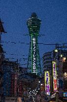 Tsutenkaku Tower lit up in green after achieving the "Osaka Model".